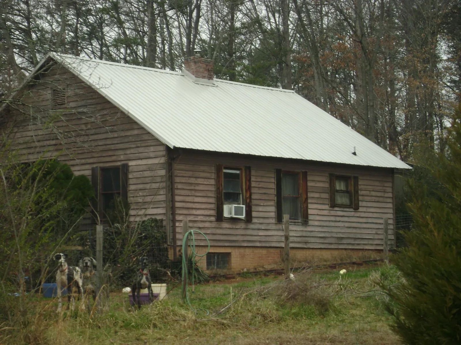 White metal roof on an old wood sided farmhouse, from a Metal Roof Installation job in East Ellijay